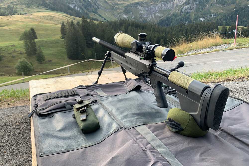 PGM Ludis rifle with Schmidt & Bender scope and mountains in the background